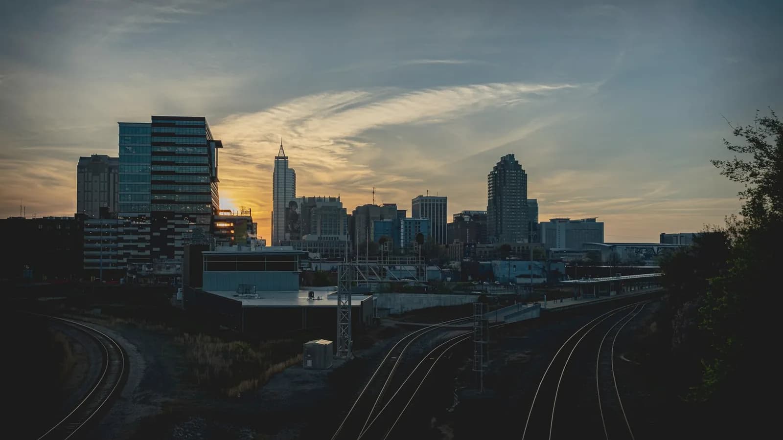 3D 4D ultrasound Raleigh NC: Raleigh North Carolina downtown skyline at golden sunset with rail tracks
