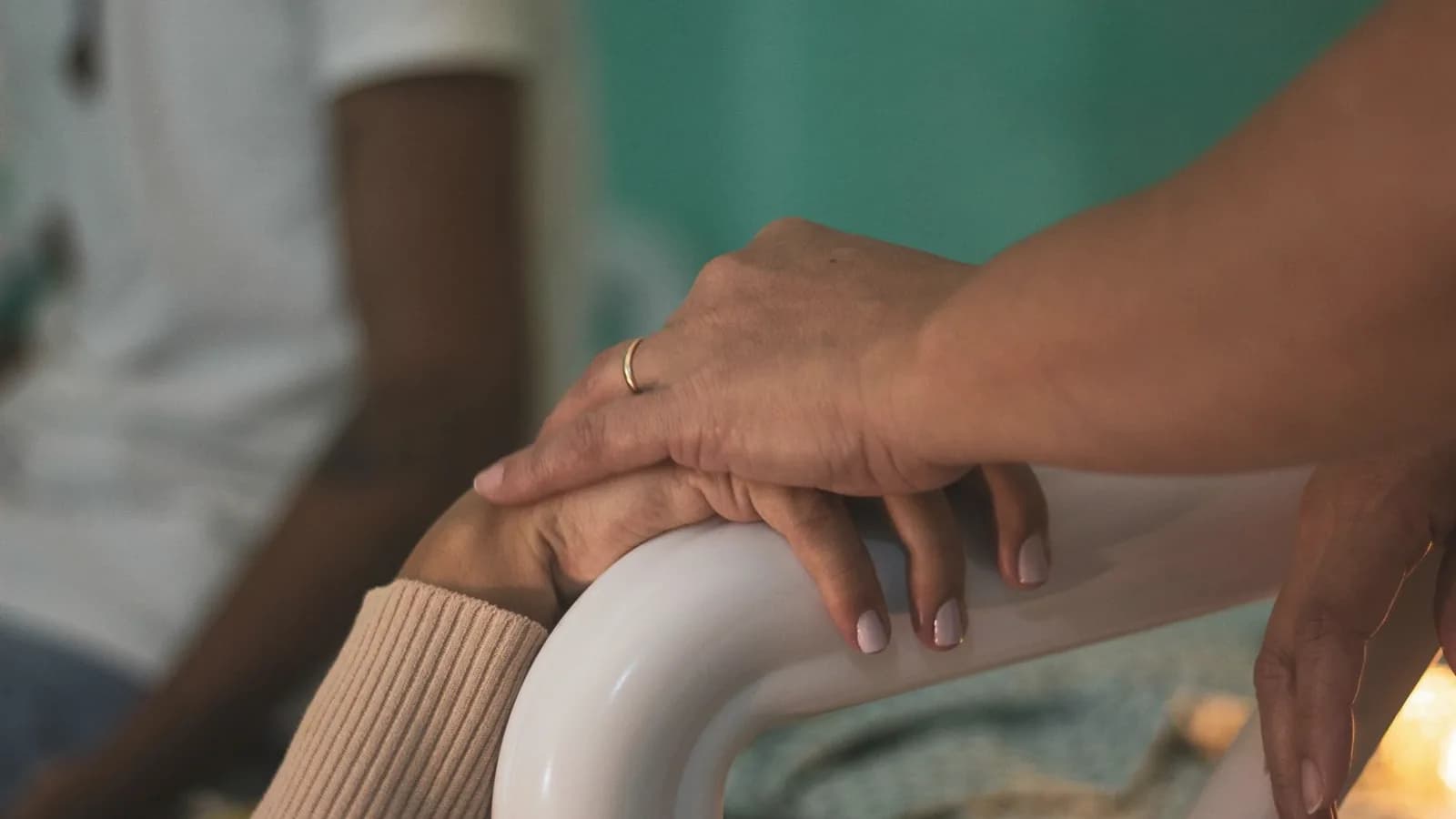 Bringing a doula to your ultrasound appointment: Close-up of a supportive hand resting comfortingly over another woman's