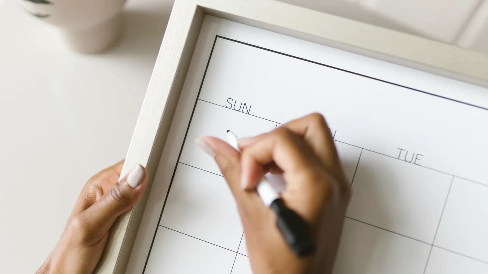 Chinese gender calendar: Hand writing on a white wall calendar with a marker