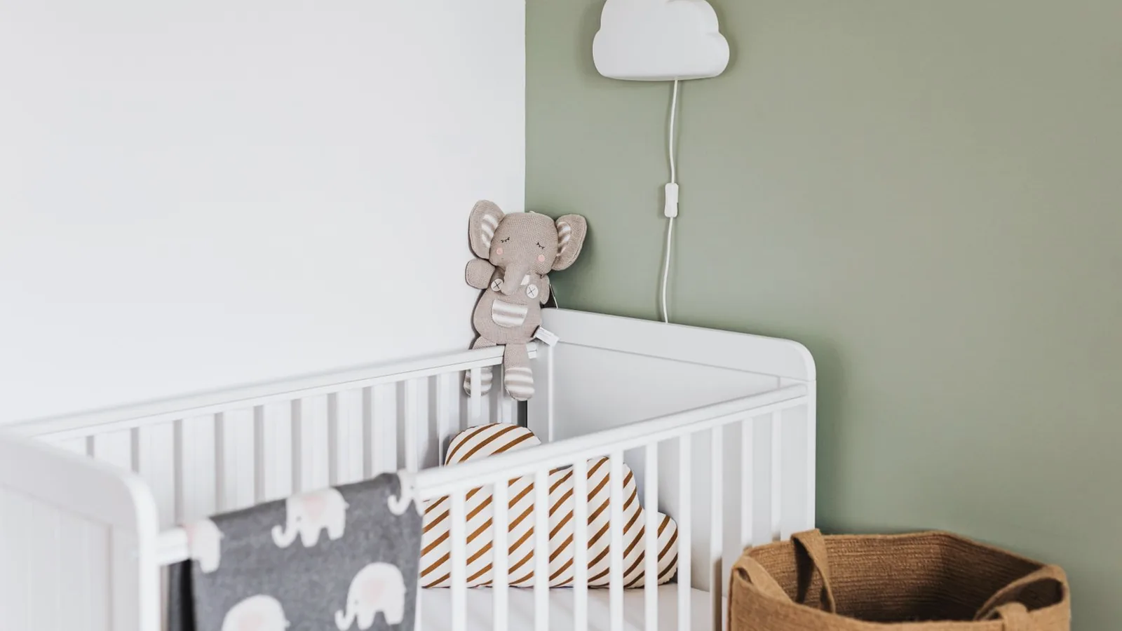 Getting ready for baby week 36: White crib and sage green wall in a soft neutral nursery